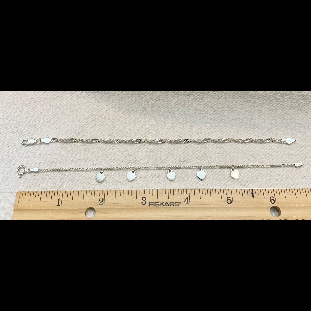 2 Sterling Silver chain bracelets, rope twist and the other is a Heart dangle.